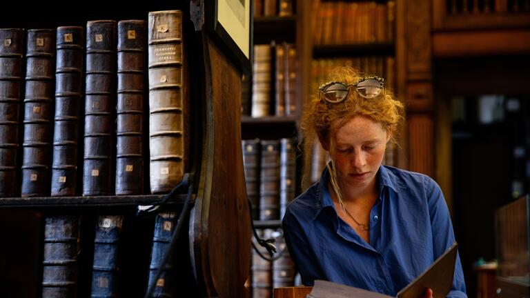 Student at Queens' College library