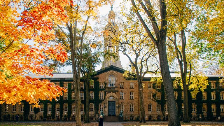 Person walking in front of building of the University of Princeton